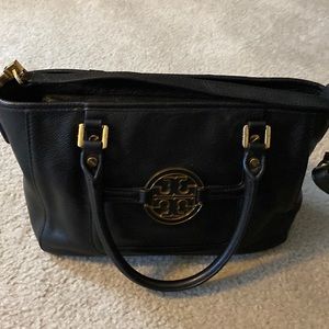 Tory Burch leather tote in black with gold trim zipper top and crossbody strap
